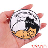 A round embroidery patch featuring a black cat sitting on an orange cat, with text reading Certified Cat Lady.