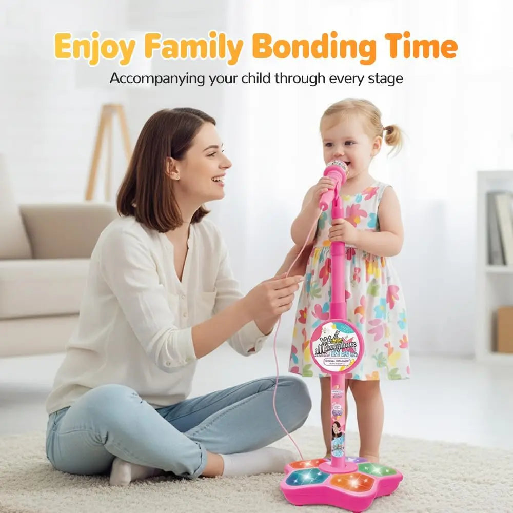 A mother and child enjoy family bonding time with a pink karaoke microphone stand.