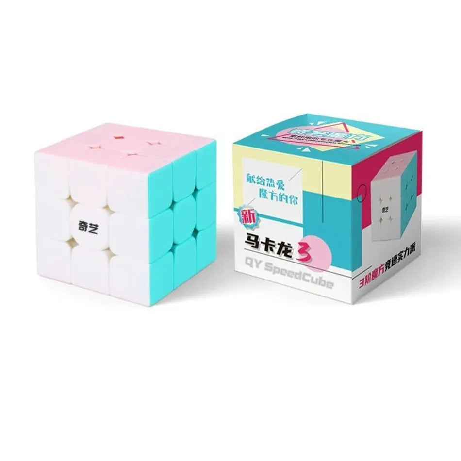 A pink QiYi Speed Cube 3x3 puzzle box with a teal-colored cube visible next to it.