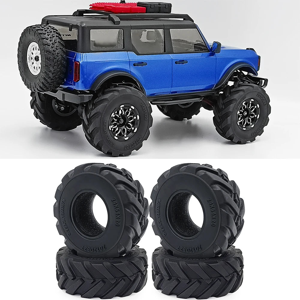 Blue RC truck with rubber mud terrain tires and a red accessory on a white background.