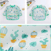 A patterned kids waterproof long sleeve smock and feeding bib featuring cactus and leaf designs.