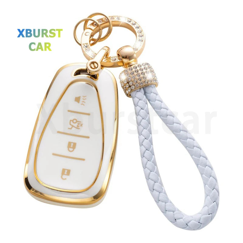 A gold-colored key fob cover with a white plastic body and a white braided strap.