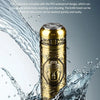 A gold-colored mini waterproof electric razor is shown being washed under running water.