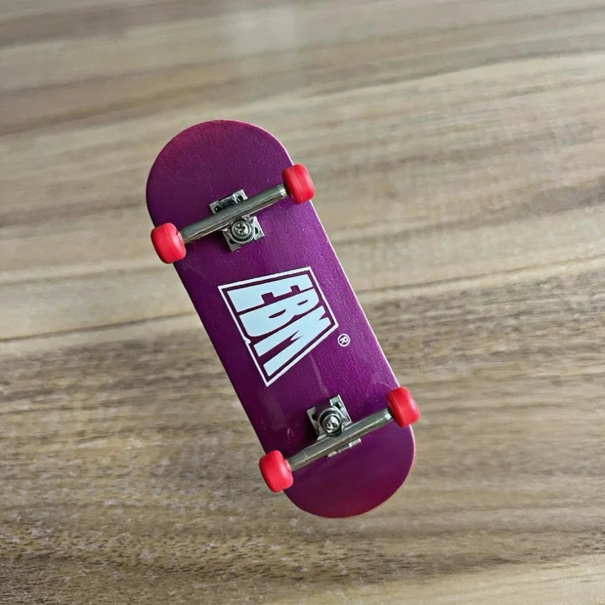 A purple skateboard with a wooden fingerboard and realistic trucks resting on a wooden surface.