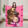 A pink flannel throw blanket featuring a cartoon design of Masha and Bear.