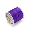 Spool of purple 0.8mm nylon macramé cord for jewelry making with a label.