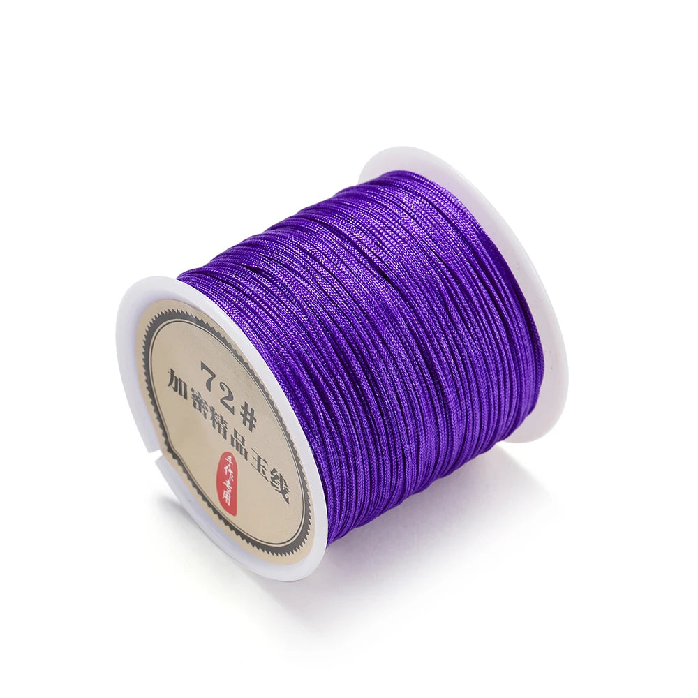 Spool of purple 0.8mm nylon macramé cord for jewelry making with a label.