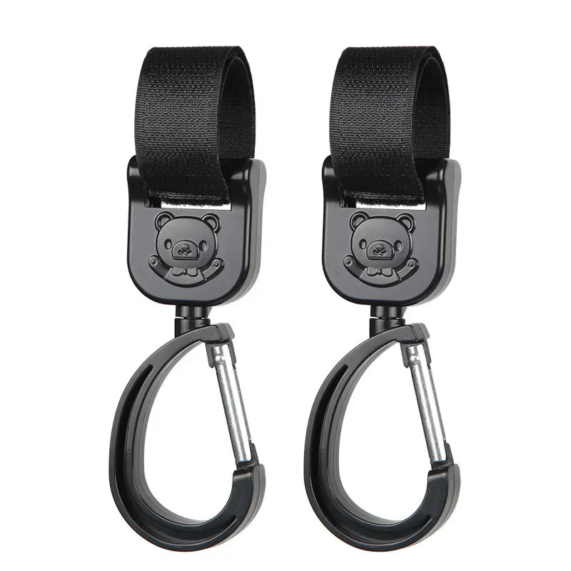 A pair of black 360° rotating stroller hooks designed for hanging bags and essentials.