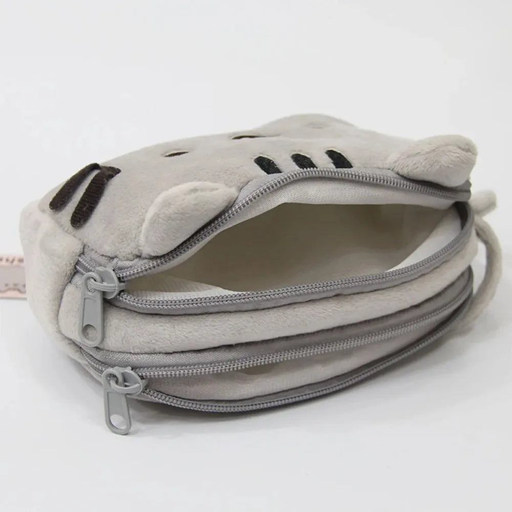 A light gray cat plush pencil case with a zipper closure is shown from the top view.