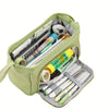 A light green canvas pencil case is open, showing various pens, pencils, and an eraser inside.