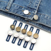 Six metal button waist extenders in various finishes are shown against a denim fabric background.