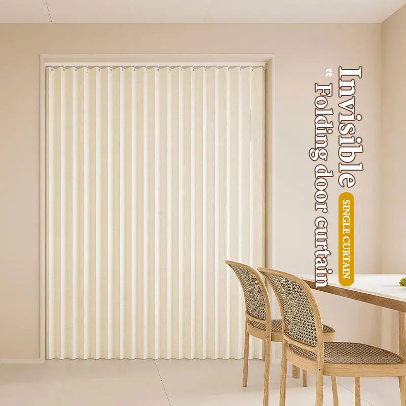 A vertical pleated light beige door curtain shown in a room setting.