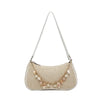 A beige straw beach shoulder bag with delicate ocean shell charms hanging from a thin strap.