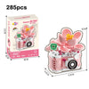 A pink and white retro camera set with flower accessories and building blocks for DIY decor.