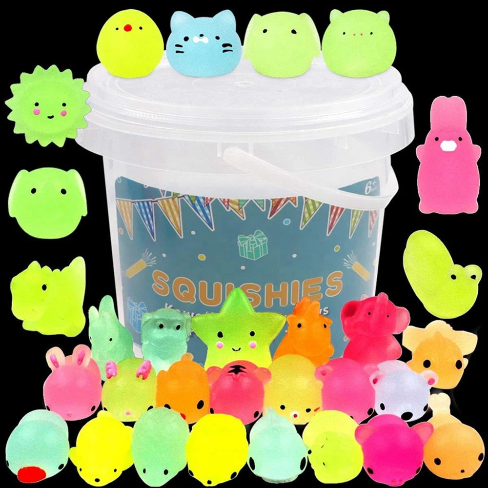 A collection of colorful, glow-in-the-dark squishy toys shaped like various cute animals in a clear plastic container.
