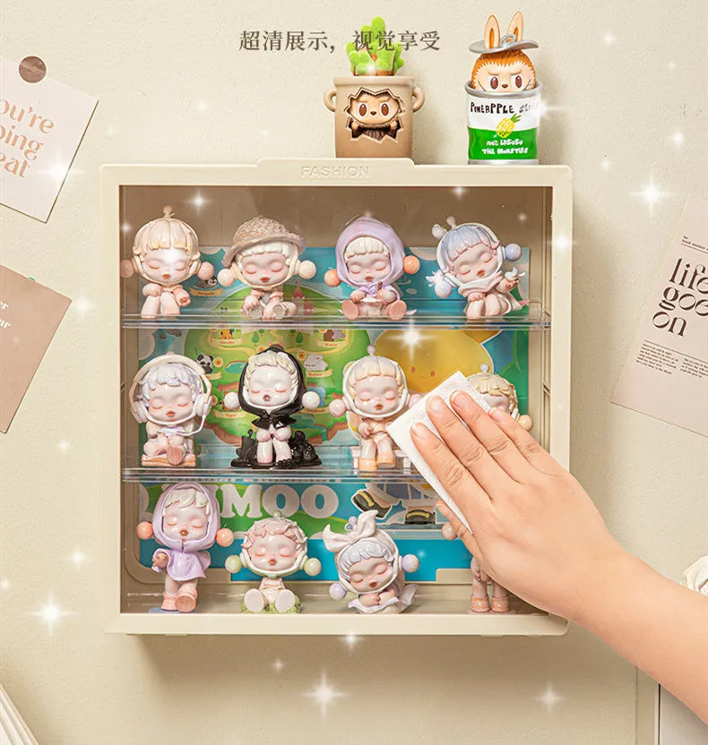 A wall-mounted display case featuring collectible dolls and a small potted plant.