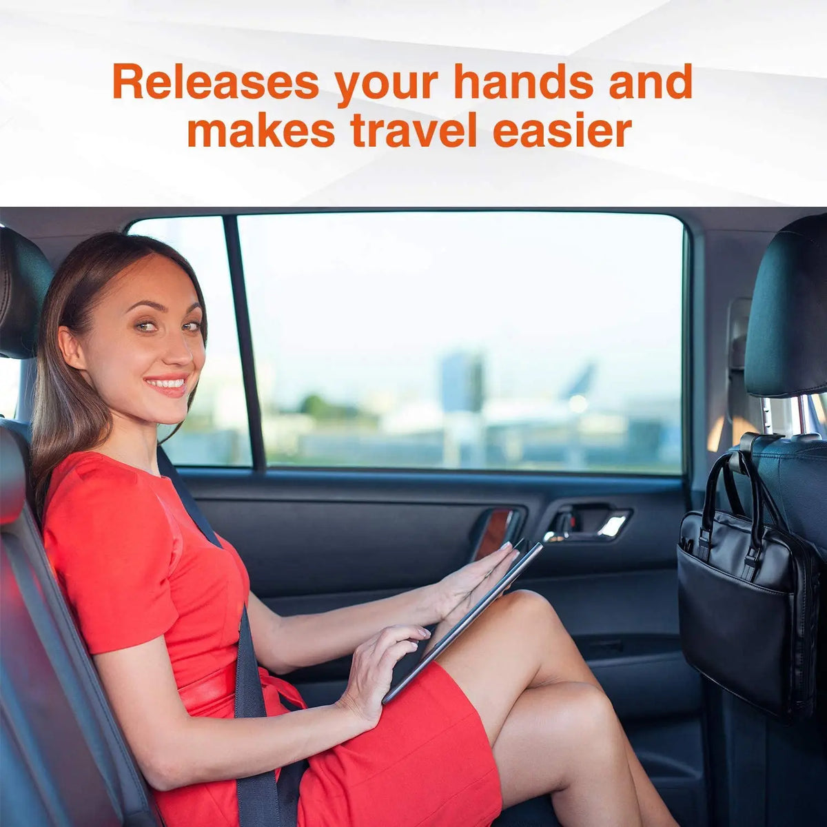 A woman in a red dress is using car seat headrest hooks to organize bags inside a car.