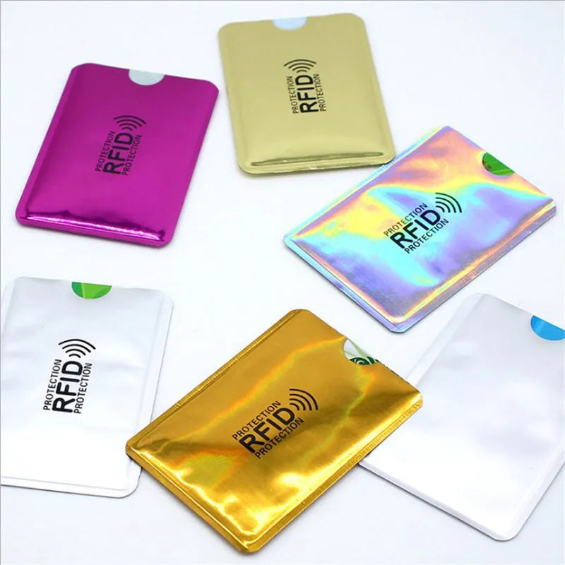 A collection of five RFID-blocking aluminum card holders in various colors including pink, gold, and silver.
