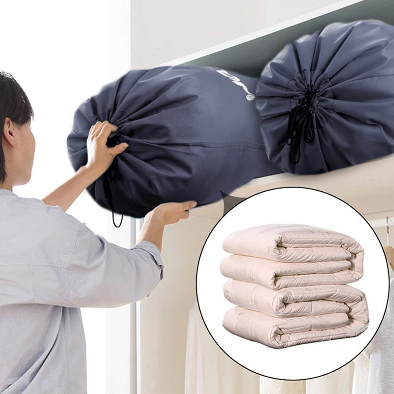 A person is holding a large navy blue drawstring laundry bag, next to a stack of folded pink towels.