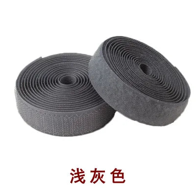 Roll of gray sew-on hook and loop tape fastener strip