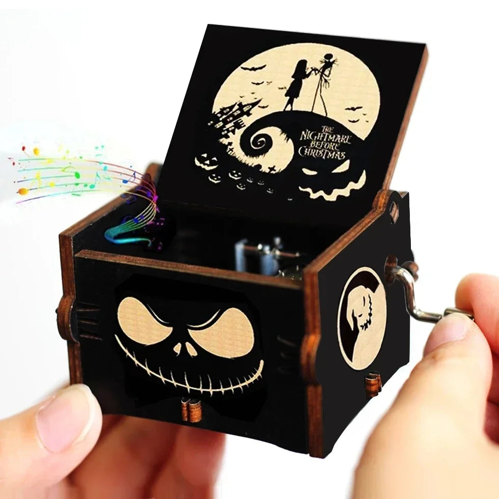 A dark wooden music box with a lid featuring a swirling silhouette and a skull design.