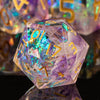 A translucent purple polyhedral die with gold numbers rests on a reflective surface.