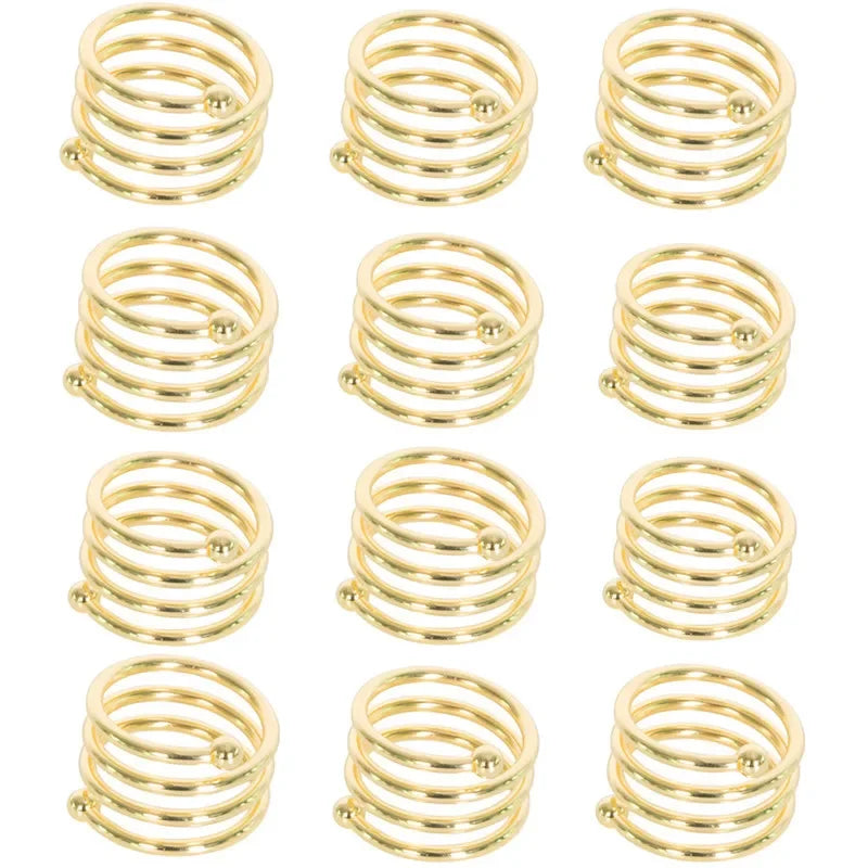 A set of twelve decorative metal napkin rings with a hollow-out pattern, gold in color.