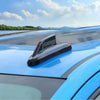 A close-up view of a black chrome-style antenna cover trim installed on the blue fender of a truck.