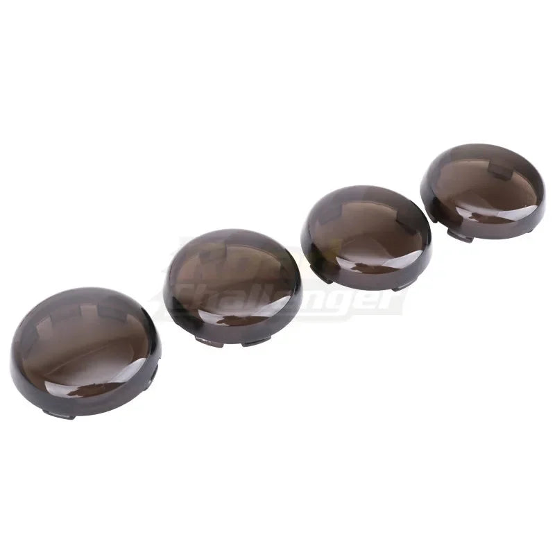 Three round, dark brown LED turn signal light lens covers for Harley Davidson motorcycles.