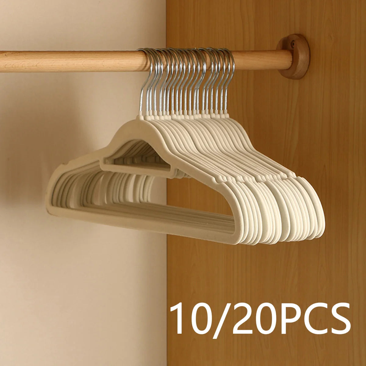 A wooden hanger with multiple velvet non-slip hangers is displayed on a wooden rod.