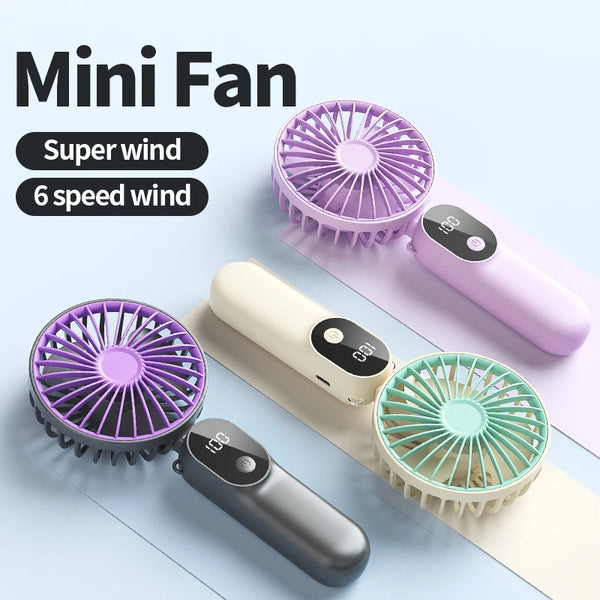 Drei Mini-Ventilatoren in lila, weiß und minzgrün auf hellem Hintergrund