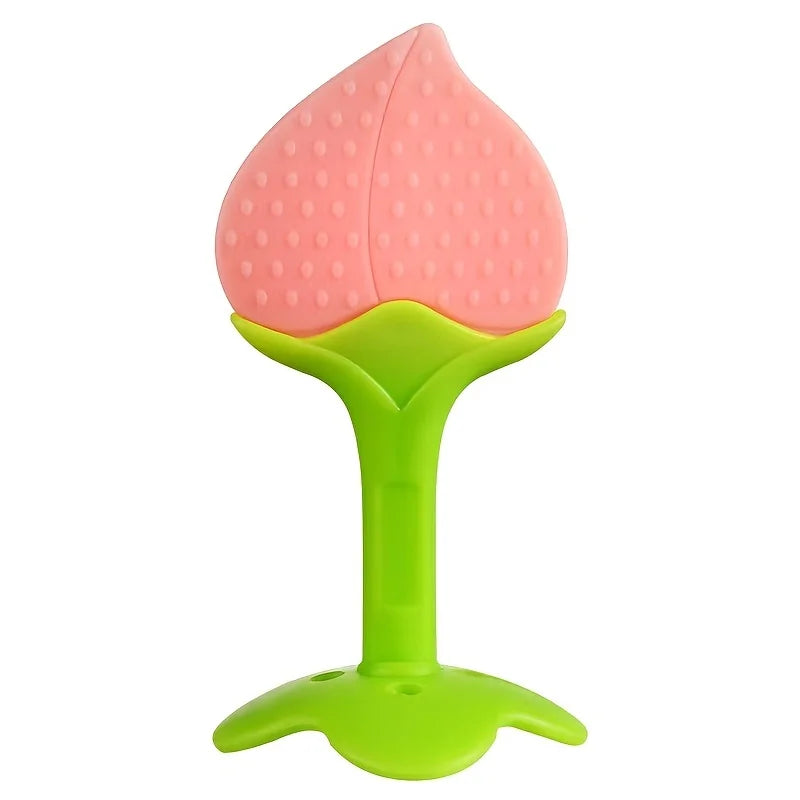A pink silicone strawberry baby teether with a green base.