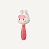 A white cartoon animal rattle toy with pink accents and a pink handle.