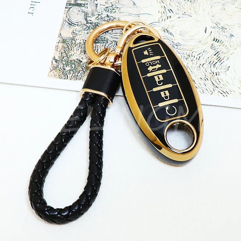 A gold and black key fob with a braided leather strap is shown against a light background.