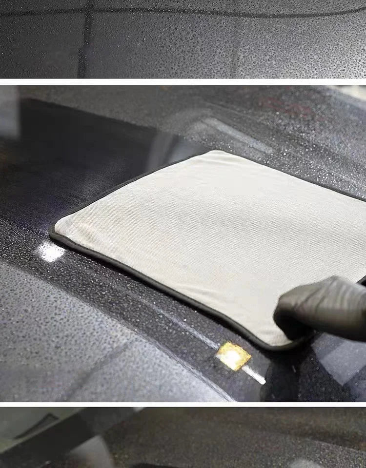 A microfiber car drying towel is being used to dry a car surface, with a small yellow cleaning tool visible.