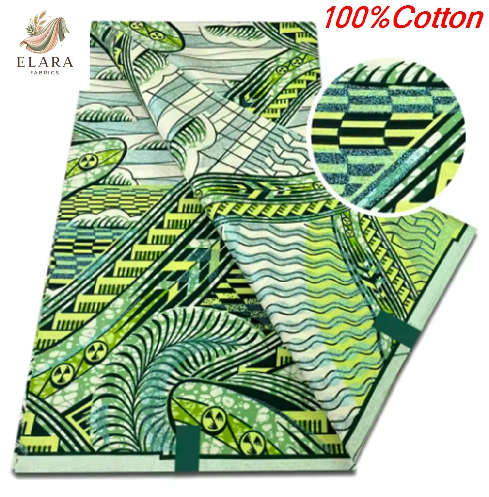 A close-up view of a green and white African wax print fabric featuring intricate patterns.