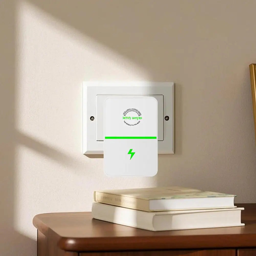 A white voltage stabilizer and energy saver plug is mounted on a wall, with a stack of books in the foreground.
