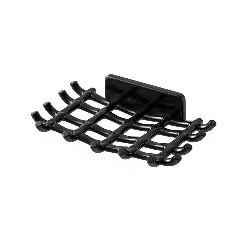 Black wall-mounted soap dish with drainage features.