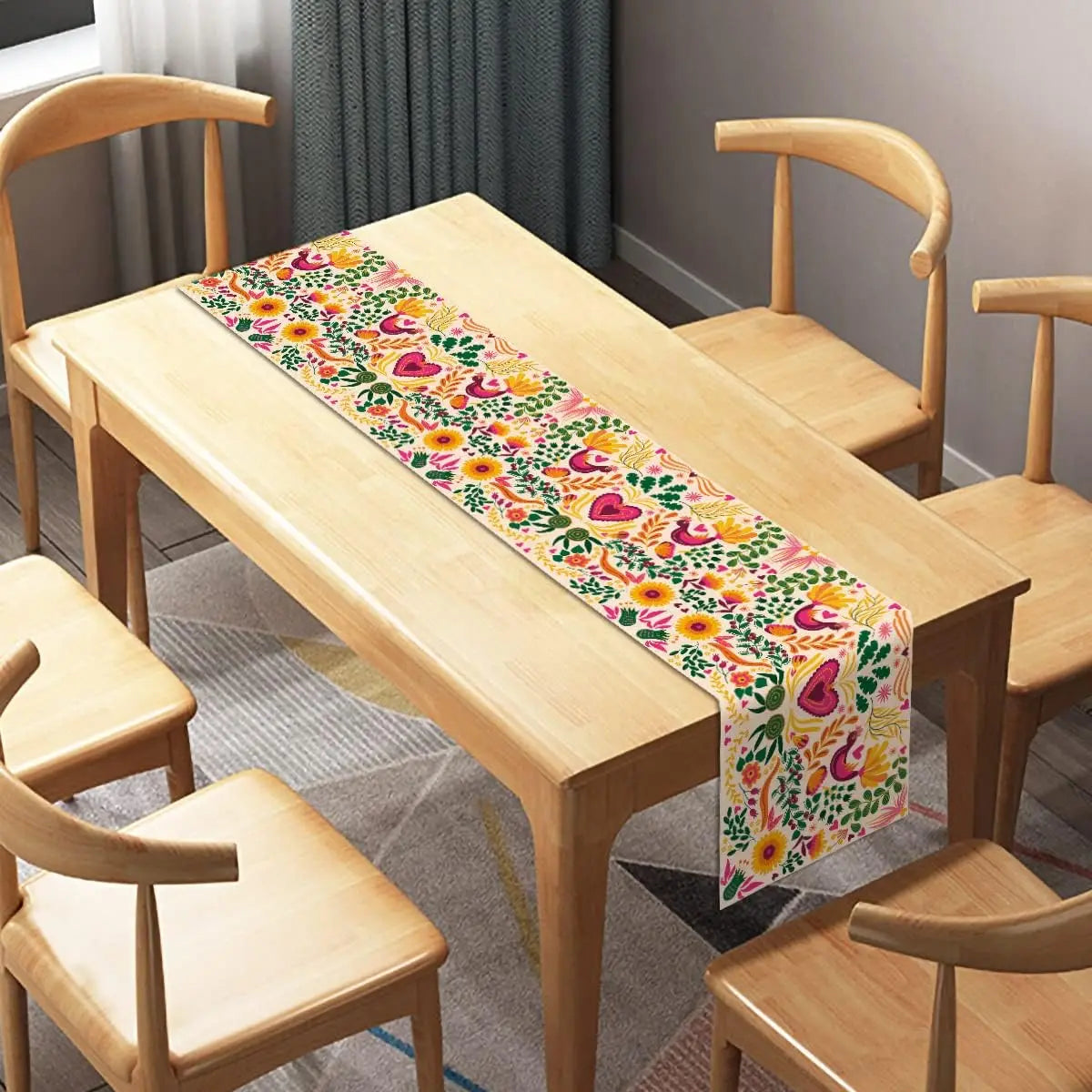 A light wood table is set with a colorful Day of the Dead Mexican Fiesta table runner featuring floral patterns.