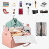 A collection of travel accessories including a duffel bag, sunglasses, jewelry, watches, and shoe pouches displayed on a whit