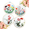 A collection of five bamboo embroidery hoops featuring floral designs in various colors and styles.