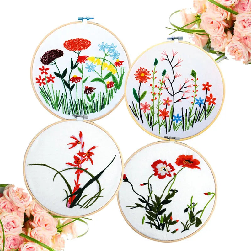 A collection of five bamboo embroidery hoops featuring floral designs in various colors and styles.