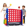 A child is playing a red and blue outdoor game set featuring a basketball hoop and ring toss targets.