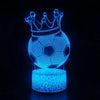 A glowing blue wireframe soccer ball crown sculpture on a stand.