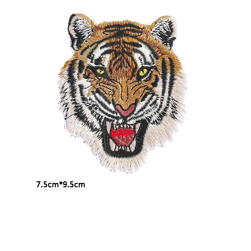 Embroidery patch of a tiger face with yellow eyes and striped fur
