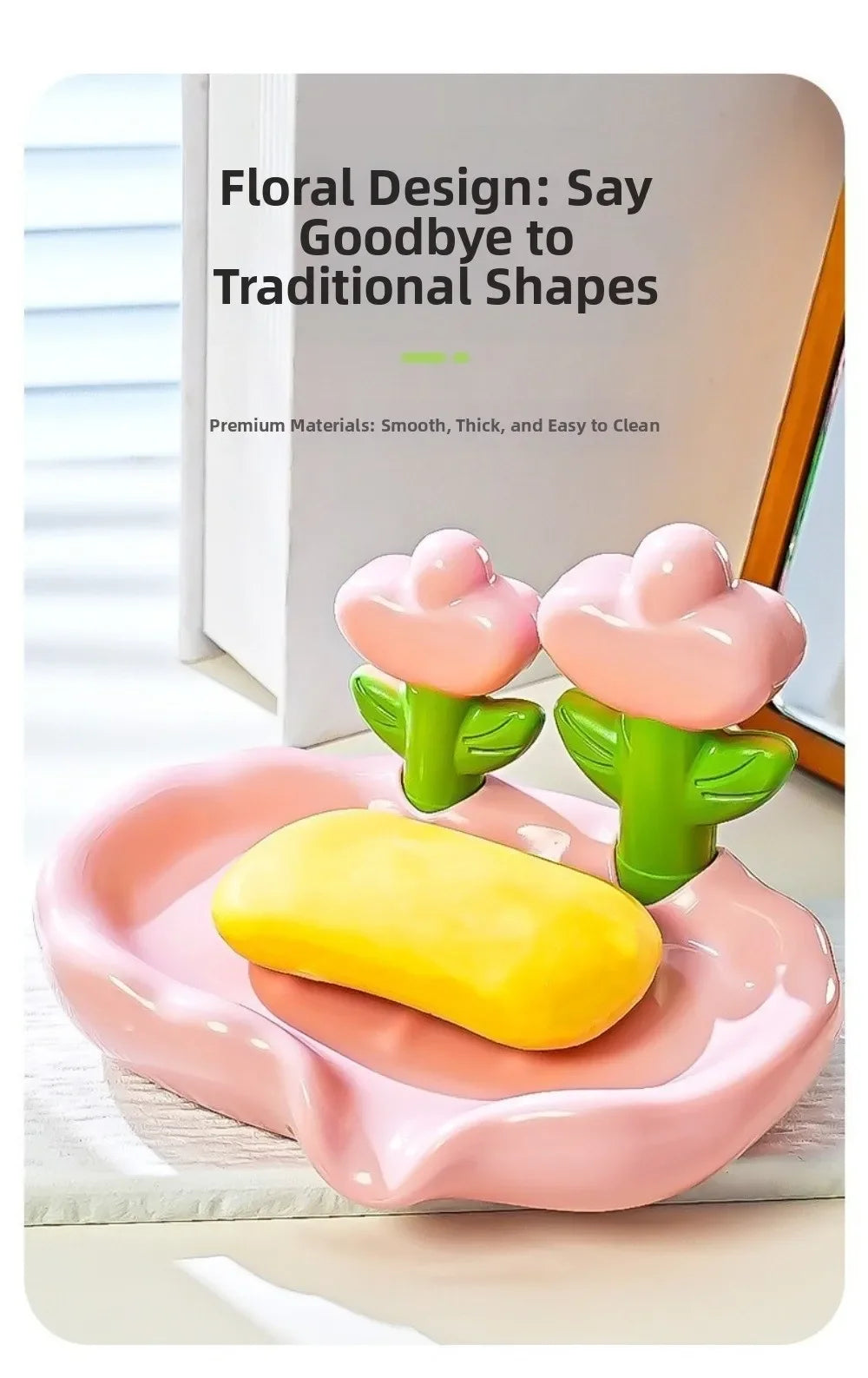Pink floral shaped soap dish with a yellow bar of soap and green stems on a white surface.