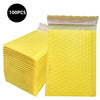 A stack of 100 yellow bubble mailers for shipping, packaged in a clear plastic bag.
