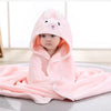 A pink fuzzy hooded baby bathrobe towel with a cartoon bunny face is draped on a white surface.