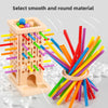 A wooden pick-up sticks game board with colorful sticks and balls for family play