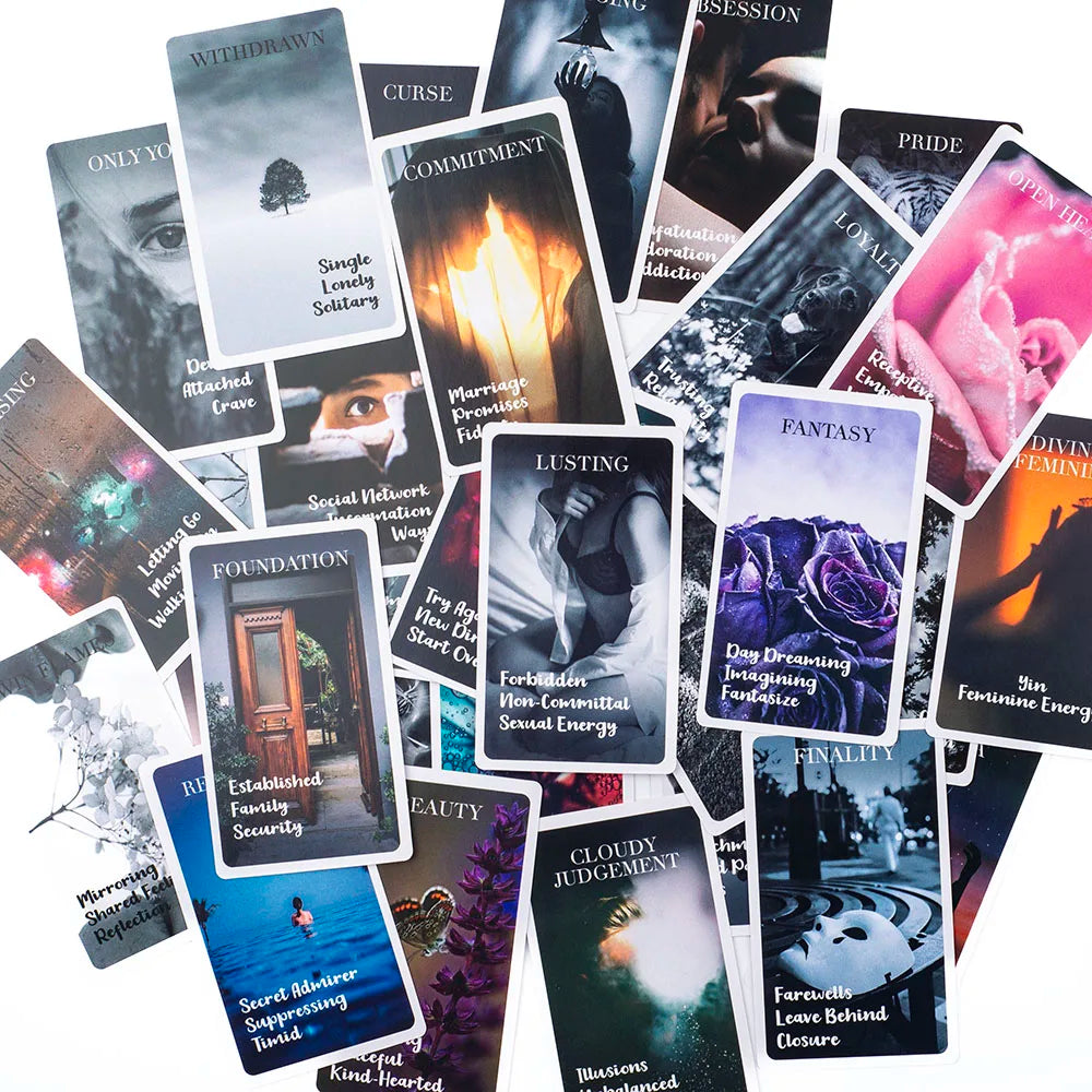 A collection of oracle cards featuring various themes like curse, promise, lusting, and fantasy.